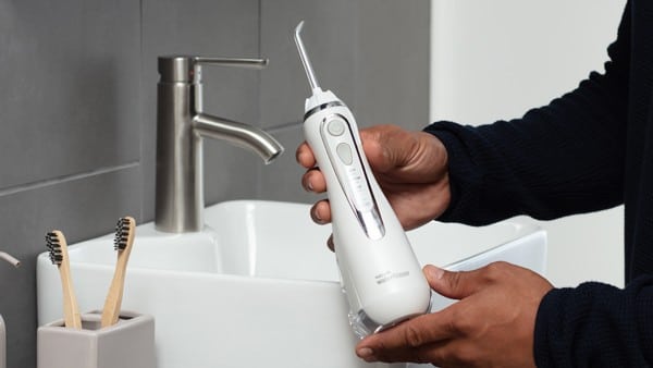Man holding water flosser